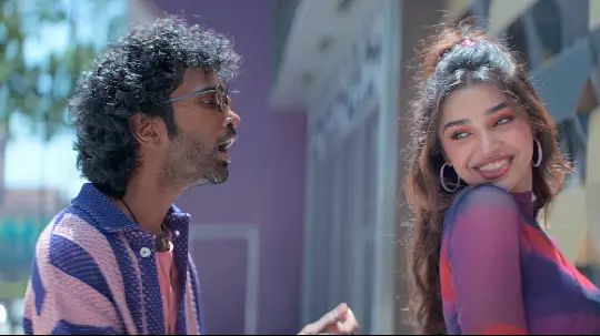 Pradeep Ranganathan is looking at Krithi Shetty, and she is smiling