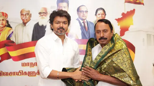 TVK Vijay is presenting a shawl to Sengottaiyan
