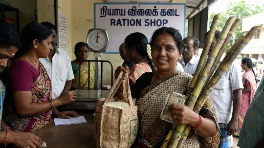 Woman with sugarcane and cash at ration shop